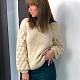 На третьей фотографии женский бежевый свитер с объемными рукавами от Shapar, бренда вязаной одежды ручной работы в интернет-магазине связанных спицами вещей.
