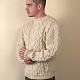 На третьей фотографии бежевый мужской джемпер с узором косами от Shapar, бренда вязаной одежды ручной работы в интернет-магазине связанных спицами вещей.