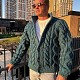 На фотографии мужской кардиган с объемными косами от Shapar бренда вязаной одежды ручной работы в интернет-магазине связанных спицами вещей.