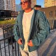 На четвертой фотографии бирюзовый мужской кардиган с объемными косами от Shapar бренда вязаной одежды ручной работы в интернет-магазине связанных спицами вещей.